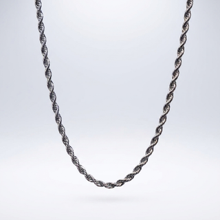 Silver rope chain necklace displayed on a soft light backdrop