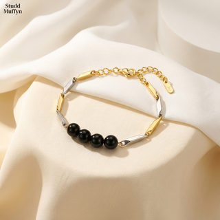 Black Obsidian dual-tone rice chain bracelet with four glossy beads and gold and silver links on a bright premium set