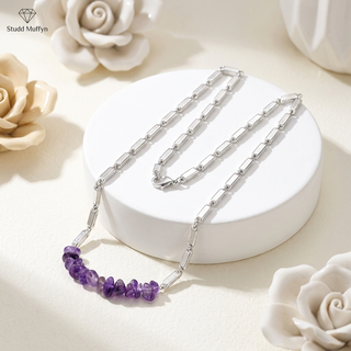 Amethyst crystal chips silver-tone chain necklace draped on a white pedestal