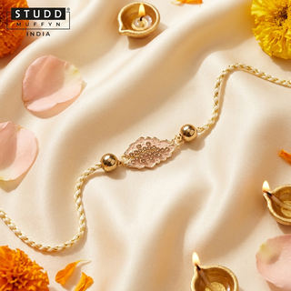 Hematite Blossom Rakhi displayed on a soft cream festive set