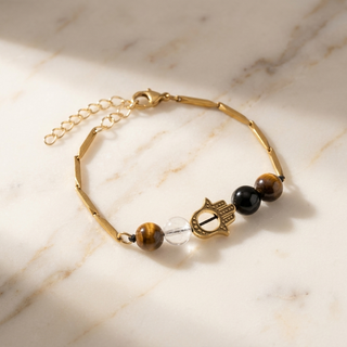 Nazar Sutra 24K gold-toned Hamsa bracelet with Tiger Eye, Clear Quartz and Obsidian crystals laid flat