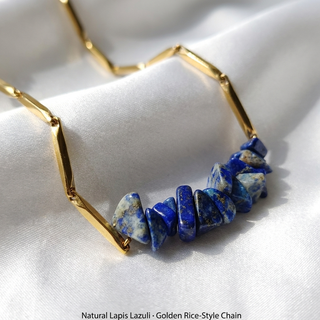 Macro close-up of natural Lapis Lazuli crystal chips and golden rice-style chain links