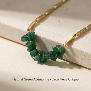 Macro close-up of natural Green Aventurine chips and polished gold rice-style links