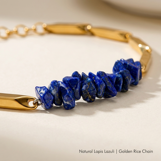 Macro close-up of natural Lapis Lazuli crystal chips and polished golden rice-chain links