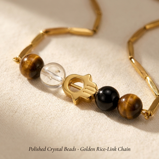 Macro close-up of the green aventurine, black obsidian and clear quartz beads and golden rice-link chain detailing