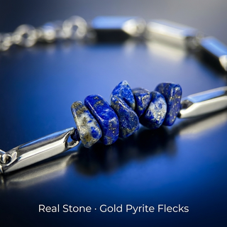 Macro close-up of natural lapis lazuli chips with golden pyrite flecks and silver rice links