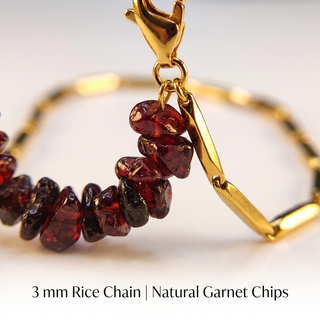 Macro close-up of natural Garnet crystal chips and the 3 mm gold-tone rice chain links