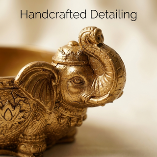 Close-up of the handcrafted elephant trunk, face and lotus detailing on the golden money bowl