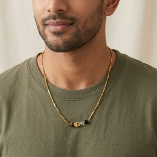 Necklace worn by a man over a plain neutral t-shirt, minimal styling