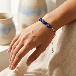 Woman wearing the lapis lazuli silver rice chain bracelet on her wrist