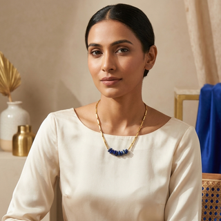 Woman wearing the Lapis Lazuli rice chain pendant necklace with an elegant neutral outfit