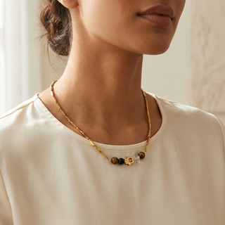 Necklace styled on a woman with a neutral top, everyday elegant look