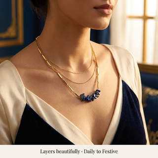 Close styling shot of the Lapis Lazuli necklace layered with gold-tone pieces on a woman