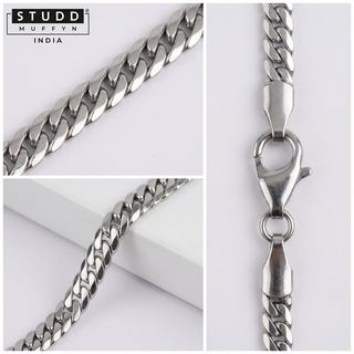 Macro detail crops of the silver flat curb chain links and clasp