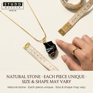 Raw obsidian pendant shown against a soft measuring tape for scale, noting each stone is unique