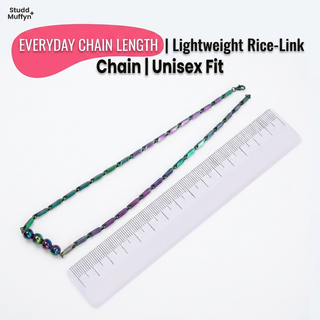 Prism Hematite Rice Chain Necklace laid along a measuring tape