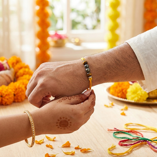 A sister tying the Unstoppable Rakhi on her brother's wrist