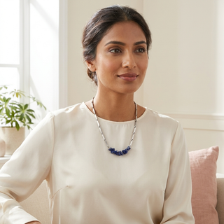 Woman wearing the Lapis Lazuli crystal rice chain pendant necklace at the collarbone