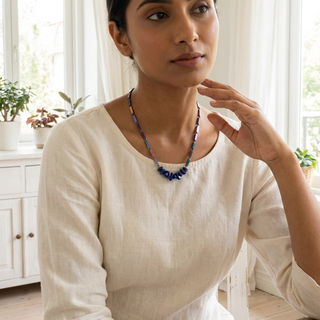 Woman wearing the Lapis Lazuli multi-coloured rice chain necklace at the collarbone
